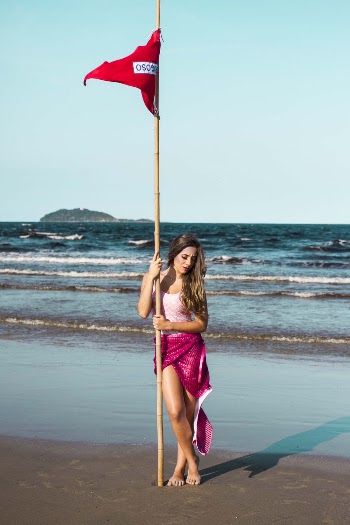 Woman Standing Holding Red Flag