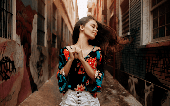 Woman Standing in Between Buildings