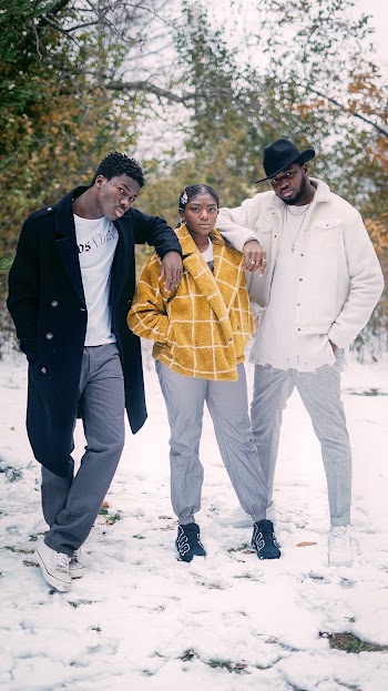 Woman Standing in Between Two Men Near Trees