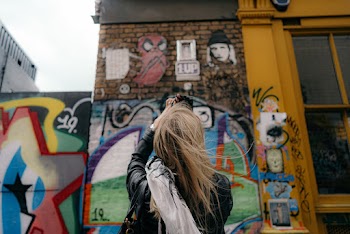 Woman Standing in Front of a Graffiti Wall