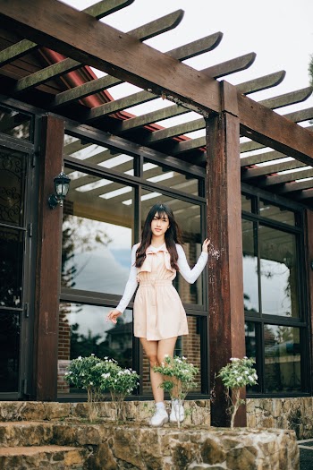Woman Standing In Front Of A House