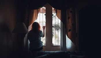 Woman Standing in Front of A Window