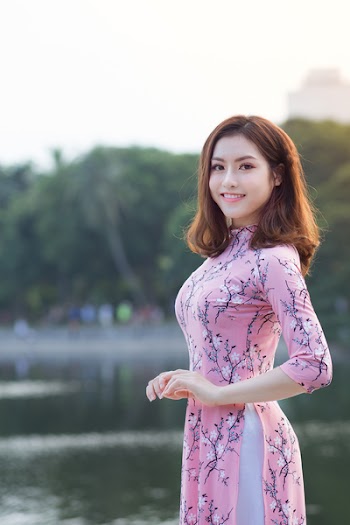 Woman Standing In Front Of Body Of Water