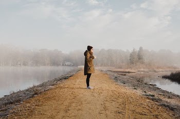 woman standing in front of body of water