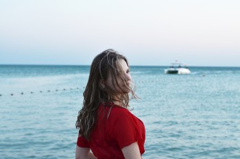 Woman Standing in Front of Body of Water