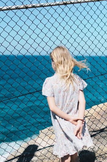woman standing in front of body of water