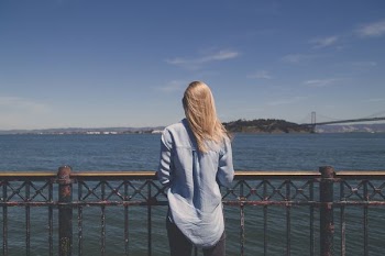 woman standing in front of body of water