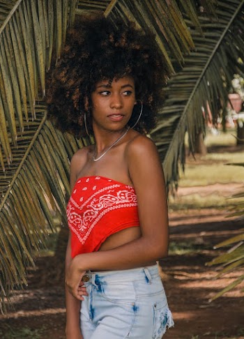 Woman Standing In Front Of Coconut Leaves