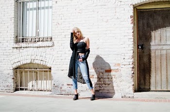 woman standing in front of concrete house