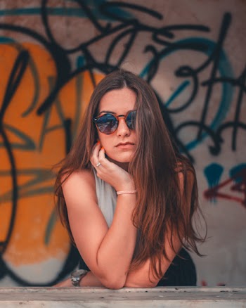 Woman Standing in Front of Graffiti-printed Wall