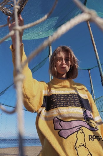 Woman Standing in Front of Gray Fence