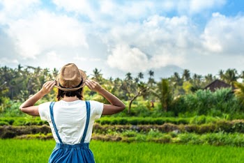 Woman Standing in Front of Green Field