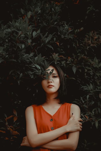 Woman Standing in Front of Green Plant