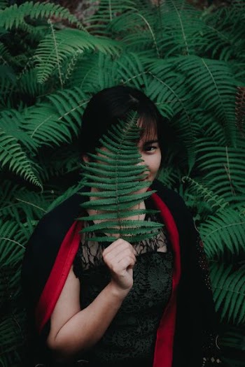woman standing in front of green plants