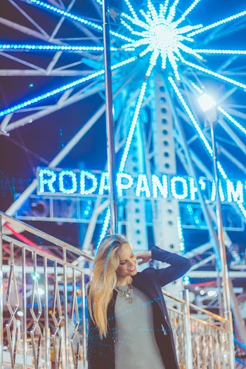 Woman Standing In Front Of Lighted Ferris Wheel