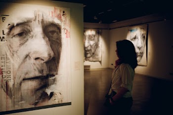 Woman Standing in Front of Man's Painting
