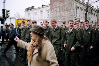 Woman Standing in Front of Military Personnel on Road