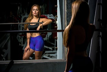 Woman Standing In Front Of Mirror