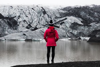 woman standing in front of mountain covered with snow