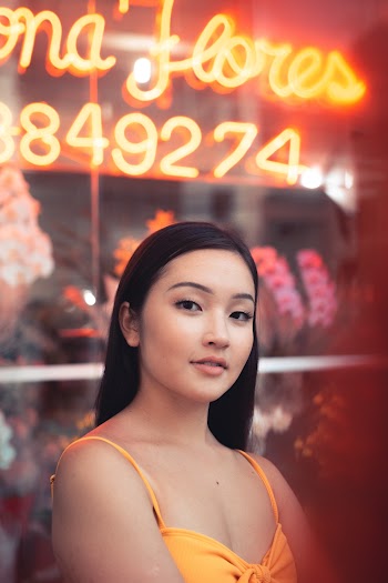 Woman Standing In Front Of Neon Sign