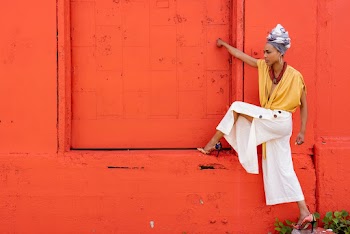 Woman Standing in Front of Orange Wall