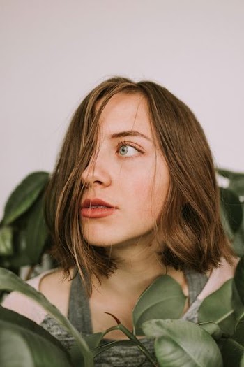 woman standing in front of plant