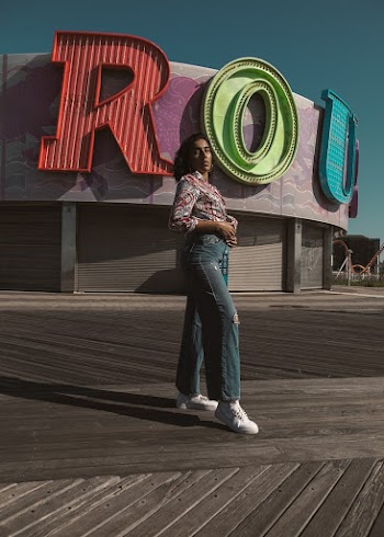 Woman Standing in Front of Purple and Gray Building
