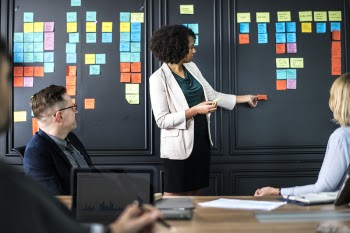 Woman Standing in Front of Sitting People