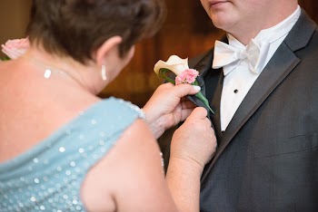 Woman Standing in Front of the Man Holding Boutonniere