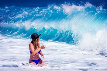 woman standing in front of water waves