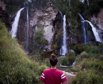 Woman Standing in Front of Waterfalls