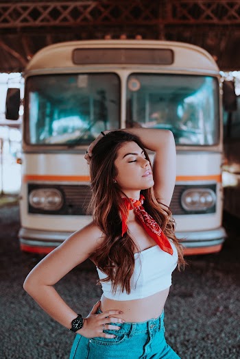 Woman Standing in Front of White Bus