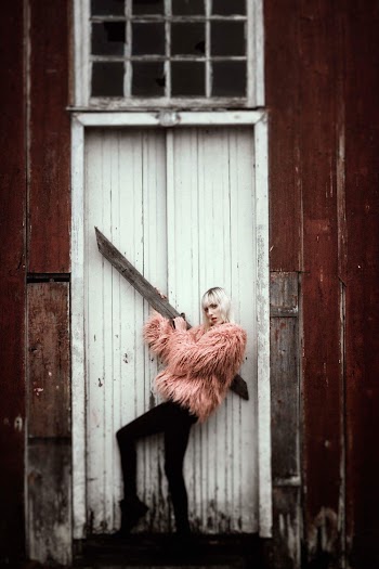 Woman Standing in Front of White Door
