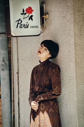 woman standing in front of white wall