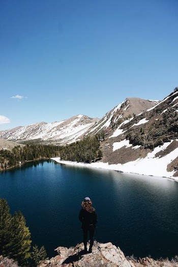 woman standing in front on body water at daytime