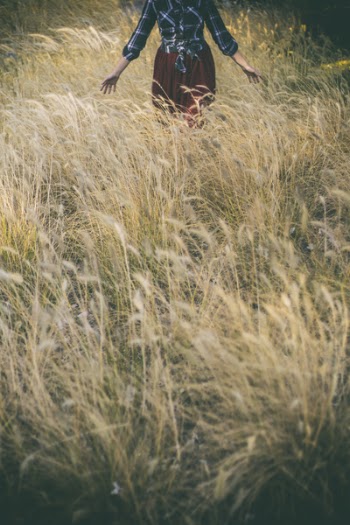 Woman Standing in Grass Field