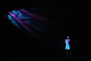 woman standing in the dark while wearing white dress