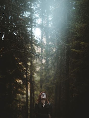 woman standing in the forest