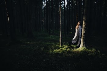 Woman Standing In The Forest