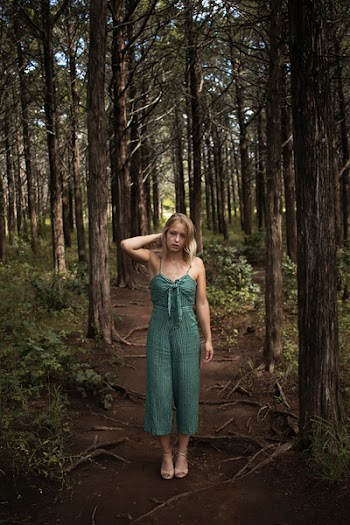 Woman Standing in the Middle of a Forest