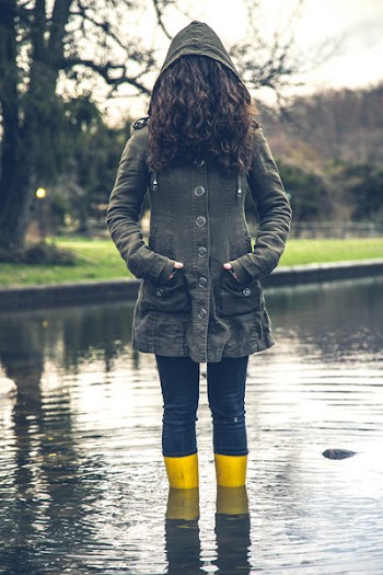Woman Standing In The Middle Of A Pond