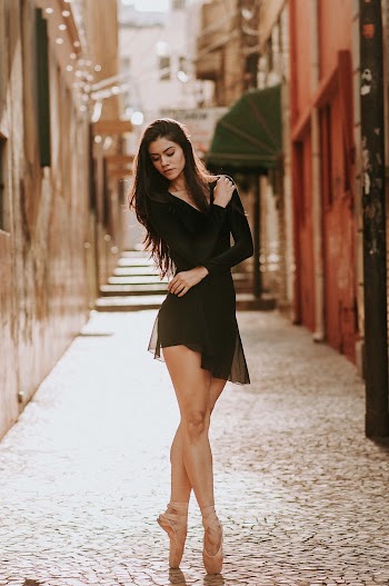 Woman Standing In The Middle Of An Alley