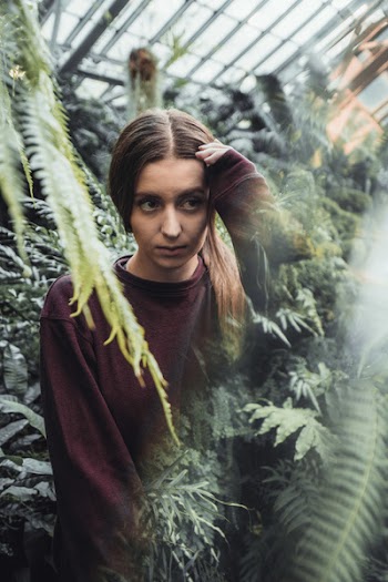 Woman Standing in the Middle of Fern Plants