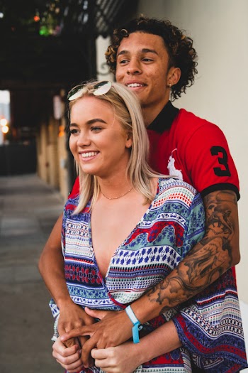 Woman Standing Infront on Man Hands over Arm