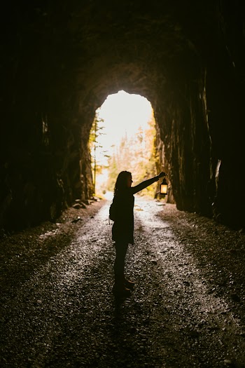 Woman Standing Inside Cave