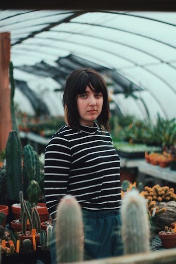 woman standing inside garden dome