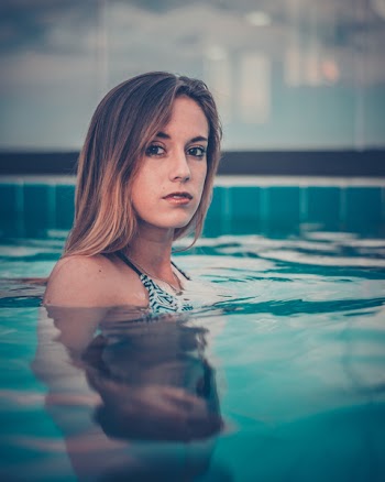 Woman Standing Inside Swimming Pool