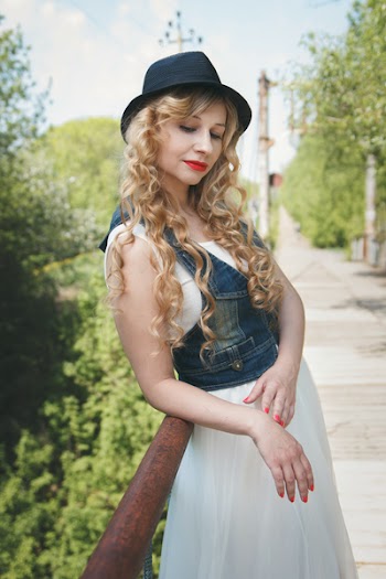 Woman Standing Leaning on Rail