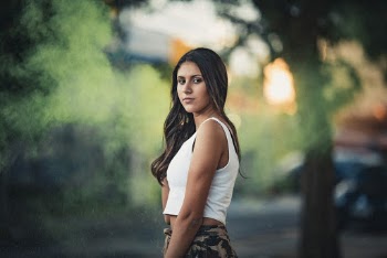 Woman Standing Looking over Her Left Shoulder Near Tree
