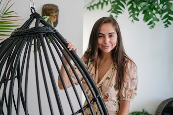 Woman Standing Near a Hanging Chair